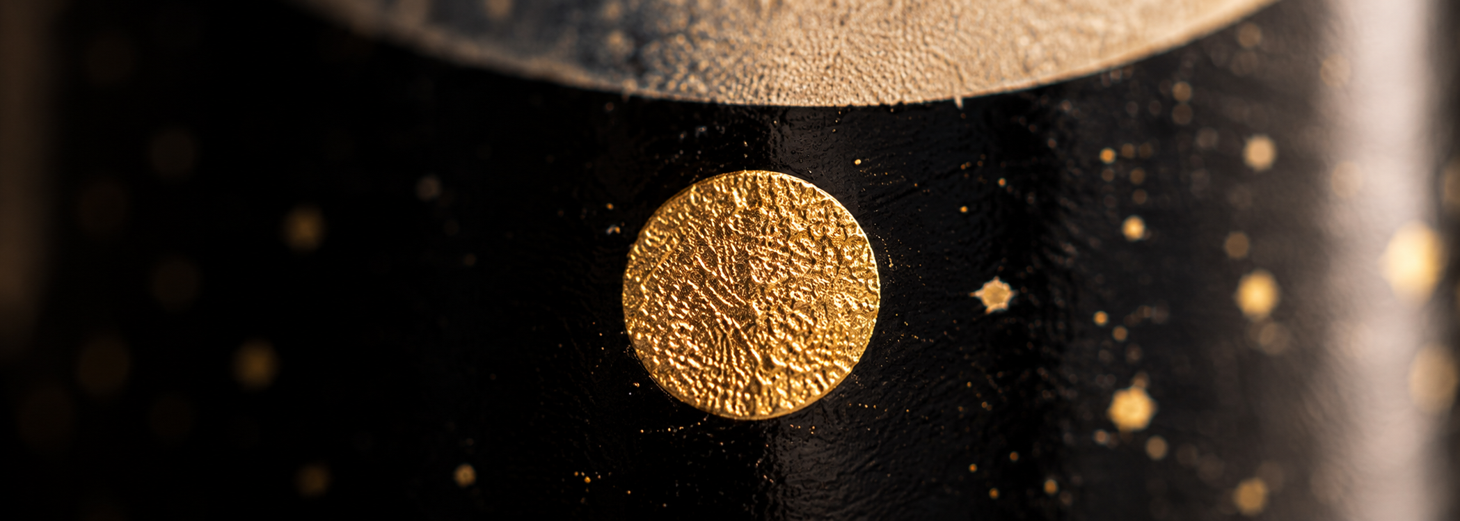 Textured gold moon dot close-up